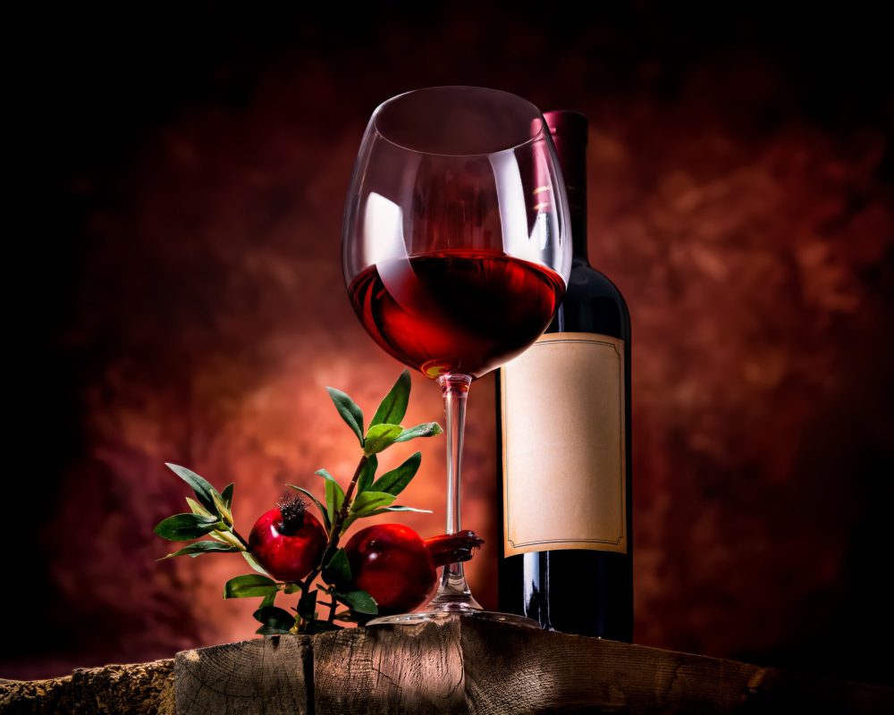 Pomegranate wine on a wooden table in a glass bowl